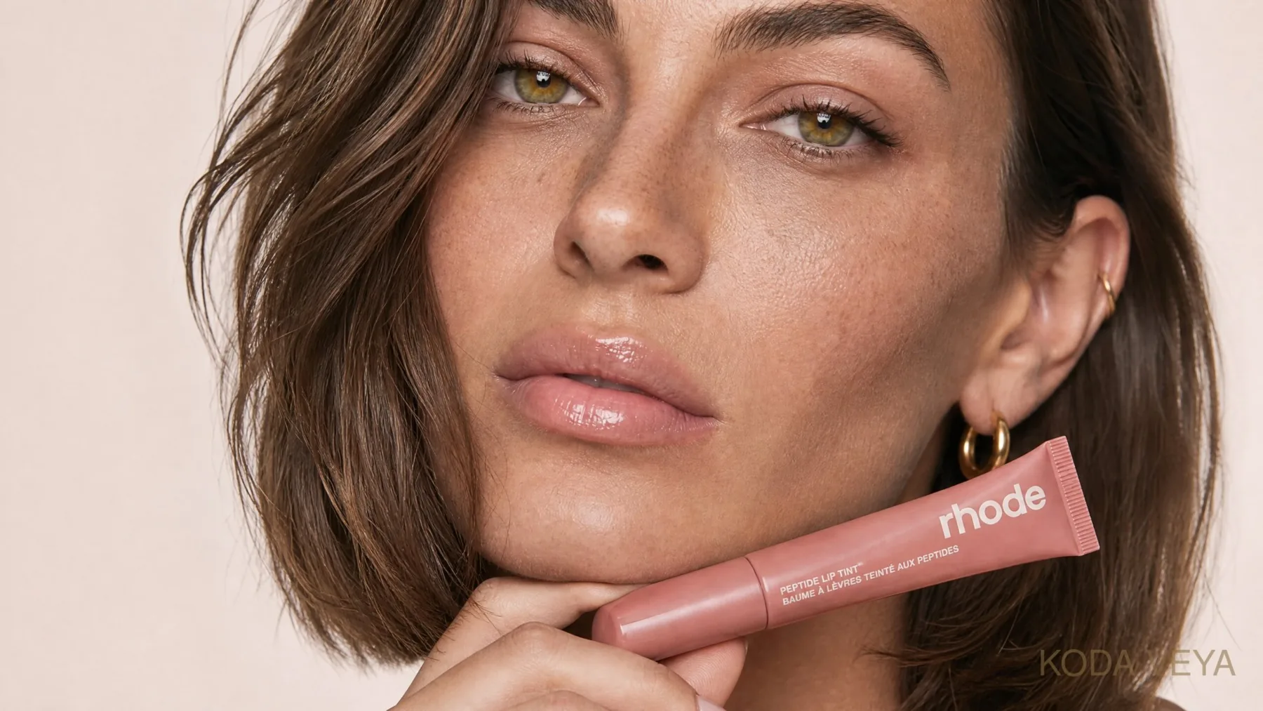 Koda with glazed skin, a soft flush and a glossy lip