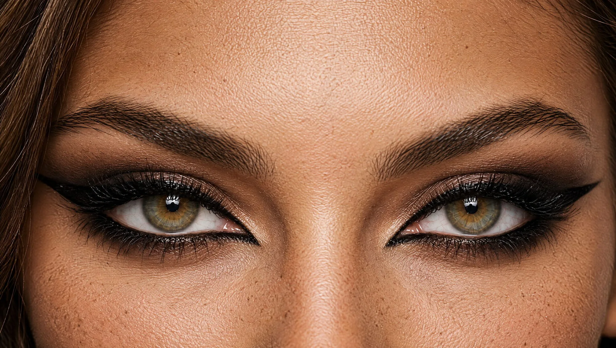 Siren eyes makeup on hazel-green eyes: a long, almost horizontal black winged liner smoked out with brown, with liner on the outer lower lashes